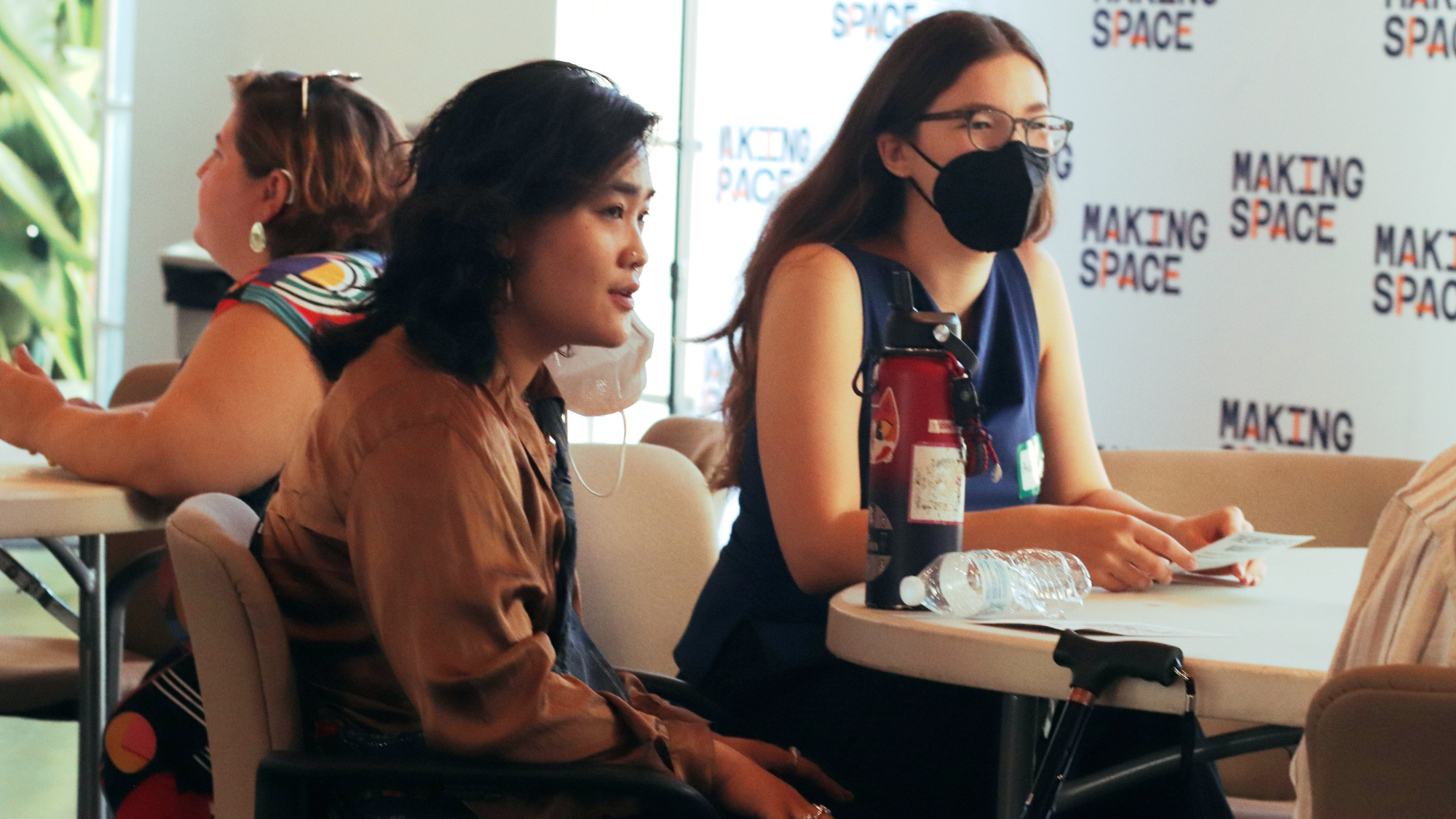 Fellows and community members in conversation at a Making Space event, with the Making Space step-and-repeat backdrop visible